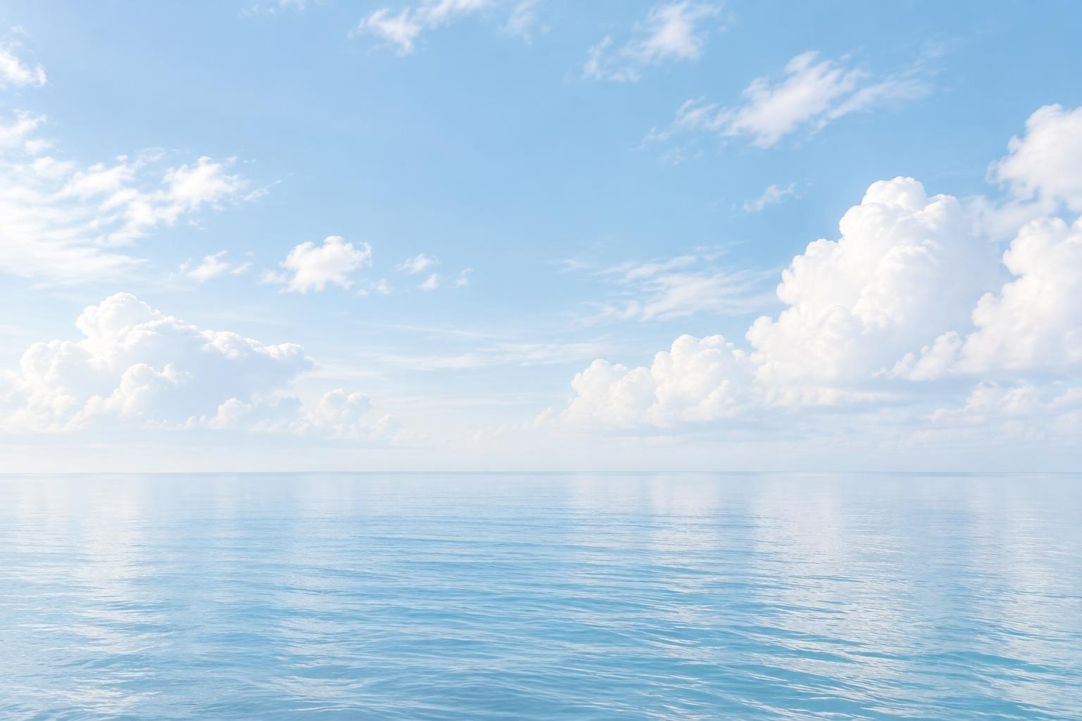 Sea beneath drifting white clouds